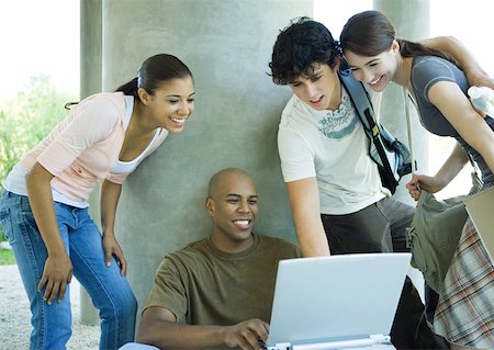 simsearch:695-03382482,k - Group of college students gathered around young man with laptop Stock Photo - Premium Royalty-Free, Code: 632-01156789