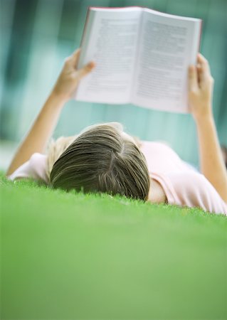 simsearch:632-03083700,k - Teenage girl lying in grass, reading book Stock Photo - Premium Royalty-Free, Code: 632-01156804