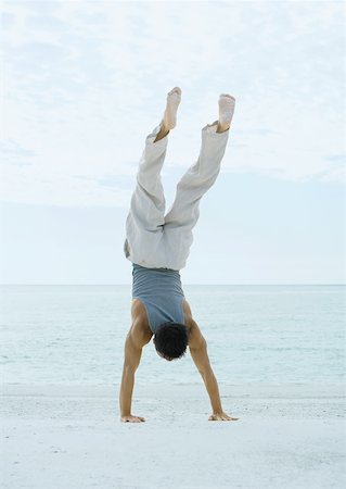 simsearch:633-01714467,k - Man doing handstand on beach Stock Photo - Premium Royalty-Free, Code: 632-01156845