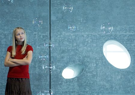 simsearch:632-05604245,k - Girl watching bubbles float in the air Stock Photo - Premium Royalty-Free, Code: 632-01156923