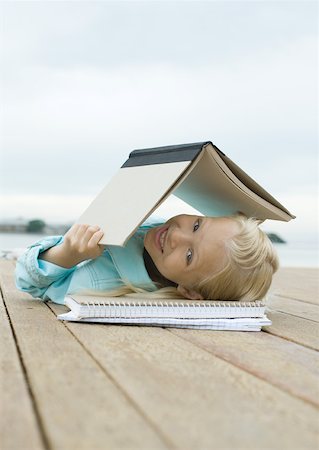 simsearch:632-01193783,k - Girl lying on dock with book over head Stock Photo - Premium Royalty-Free, Code: 632-01157047