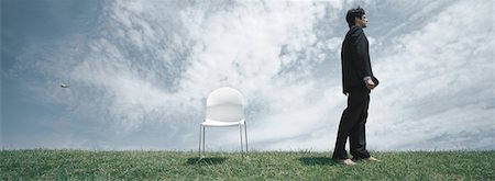 simsearch:632-03500607,k - Businessman standing on grass near chair Stock Photo - Premium Royalty-Free, Code: 632-01158940