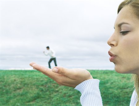 Man standing on woman's hand, optical illusion Stock Photo - Premium Royalty-Free, Code: 632-01159043