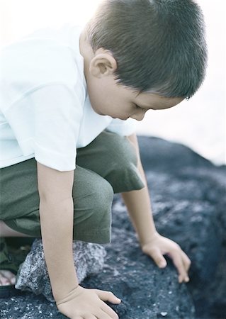 simsearch:633-05401710,k - Child crouching on rock, close-up Stock Photo - Premium Royalty-Free, Code: 632-01150365
