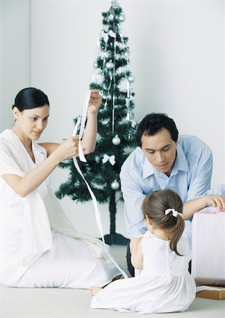 simsearch:6113-07790394,k - Little girl sitting on floor with parents near Christmas tree Stock Photo - Premium Royalty-Free, Code: 632-01151582