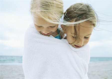 Two girls wrapped in same towel on beach Stock Photo - Premium Royalty-Free, Code: 632-01152189