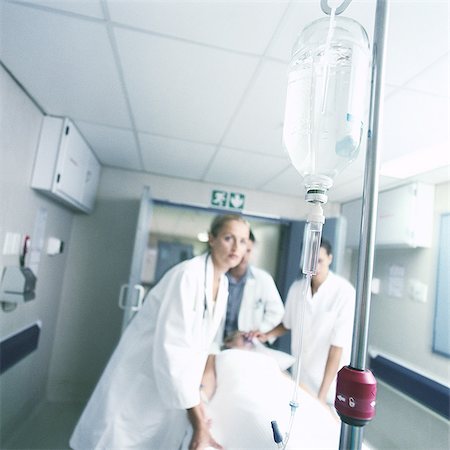 doctor intern male white - Medical team moving patient on gurney Stock Photo - Premium Royalty-Free, Code: 632-01152785