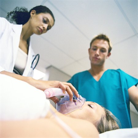 resuscitation - Doctor adjusting patient's oxygen mask Stock Photo - Premium Royalty-Free, Code: 632-01152799