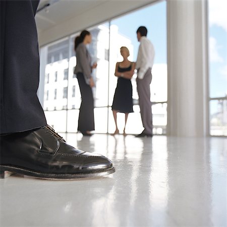 simsearch:632-05604001,k - Well-dressed man's leg, well-dressed group standing near window Stock Photo - Premium Royalty-Free, Code: 632-01152883