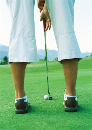 simsearch:6113-07159316,k - Golfer preparing to swing, low section, rear view Stock Photo - Premium Royalty-Free, Code: 632-01153247