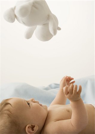 simsearch:632-03027302,k - Baby lying on back, looking up at toy Stock Photo - Premium Royalty-Free, Code: 632-01153298