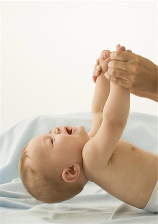 simsearch:632-03027302,k - Parent lifting baby by hands. cropped Stock Photo - Premium Royalty-Free, Code: 632-01153299