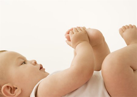 simsearch:632-03027302,k - Baby lying down, holding foot Stock Photo - Premium Royalty-Free, Code: 632-01153290