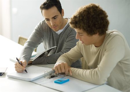 father son study - Father helping teenage son with homework Stock Photo - Premium Royalty-Free, Code: 632-01193817
