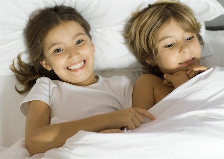 Brother and sister lying in bed together Stock Photo - Premium Royalty-Free, Code: 632-01193865