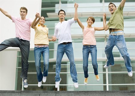 Teens holding hands and jumping in the air Stock Photo - Premium Royalty-Free, Code: 632-01193938