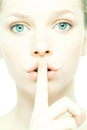 shhh - Teenage girl holding finger over lips, close-up, front view Stock Photo - Premium Royalty-Free, Code: 632-01277722