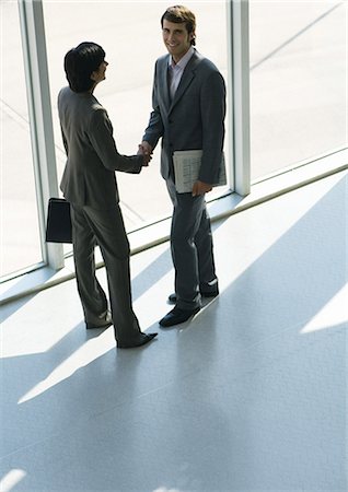 Business associates shaking hands, full length, high angle view Stock Photo - Premium Royalty-Free, Code: 632-01270359