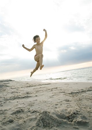 Child jumping on beach Stock Photo - Premium Royalty-Free, Code: 632-01270488