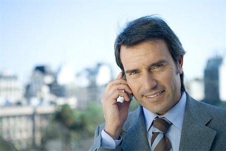 simsearch:695-03376228,k - Businessman using cell phone, cityscape in background Stock Photo - Premium Royalty-Free, Code: 632-01270655