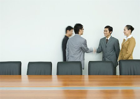 Business executives shaking hands in conference room Stock Photo - Premium Royalty-Free, Code: 632-01271140