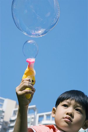simsearch:632-05604245,k - Boy making bubbles with bubble gun Stock Photo - Premium Royalty-Free, Code: 632-01271465