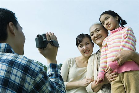simsearch:696-03401677,k - Man taking photo of three generations of women Stock Photo - Premium Royalty-Free, Code: 632-01271491
