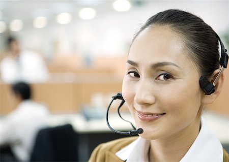 switchboard operator - Woman wearing headset, smiling at camera Stock Photo - Premium Royalty-Free, Code: 632-01271581