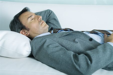 Businessman sleeping on sofa Stock Photo - Premium Royalty-Free, Code: 632-01271705