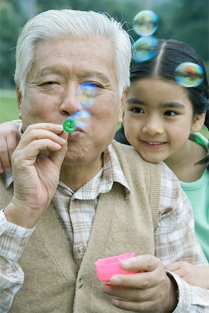 simsearch:632-05604245,k - Girl with grandfather blowing bubbles Stock Photo - Premium Royalty-Free, Code: 632-01271805