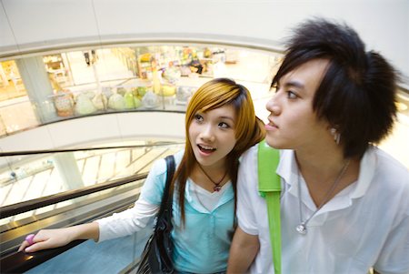 simsearch:694-03318481,k - Teenage couple riding escalator in mall Stock Photo - Premium Royalty-Free, Code: 632-01271949