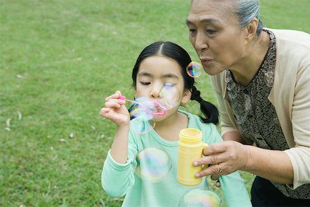 simsearch:632-05604245,k - Little girl and grandmother blowing bubbles Stock Photo - Premium Royalty-Free, Code: 632-01272039