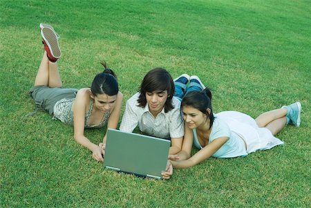 simsearch:633-01715612,k - Group of young friends lying on grass, using laptop Stock Photo - Premium Royalty-Free, Code: 632-01380141