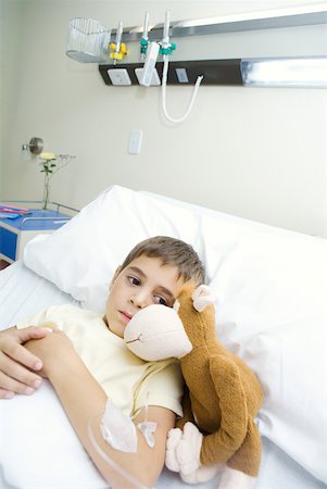 dreading - Boy lying in hospital bed next to stuffed animal Stock Photo - Premium Royalty-Free, Code: 632-01380268