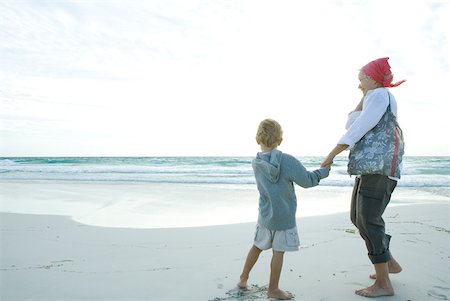 Senior woman standing on beach with grandson Stock Photo - Premium Royalty-Free, Code: 632-01380367