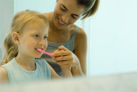 simsearch:696-03395895,k - Mother and daughter brushing girl's teeth together Stock Photo - Premium Royalty-Free, Code: 632-01380664