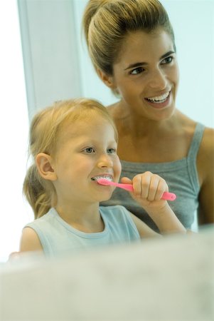 simsearch:696-03395895,k - Mother and daughter together while girl brushes teeth Stock Photo - Premium Royalty-Free, Code: 632-01380697