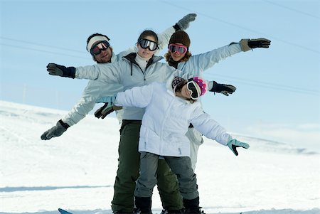 simsearch:632-01156716,k - Jeunes skieurs debout sur la piste de ski avec les bras tendus, portrait pleine longueur Photographie de stock - Premium Libres de Droits, Code: 632-01380773