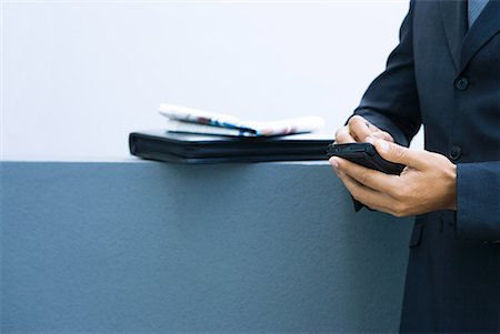 day calendar with plans - Businessman using palmtop, side view, cropped view of hands Stock Photo - Premium Royalty-Free, Code: 632-01612143