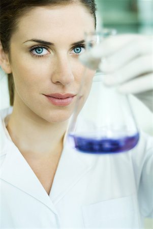 Young researcher holding up conical flask Stock Photo - Premium Royalty-Free, Code: 632-01612787