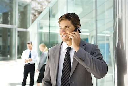 simsearch:695-03376228,k - Businessman using cell phone, smiling Stock Photo - Premium Royalty-Free, Code: 632-01612861