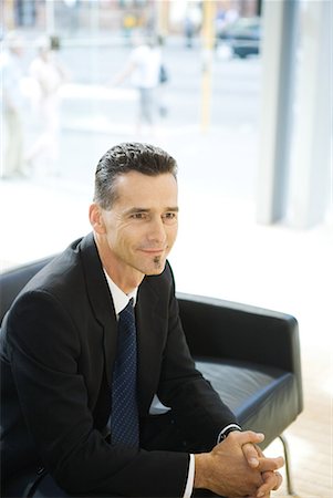 soul patch - Businessman sitting in office lobby with hands clasped Stock Photo - Premium Royalty-Free, Code: 632-01612880