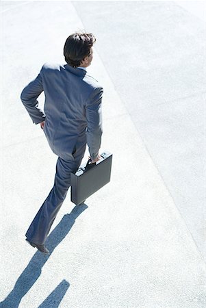 Businessman carrying briefcase, high angle view Stock Photo - Premium Royalty-Free, Code: 632-01612922