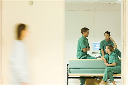 doctor nurse walking - Medical staff chatting in office, view through doorway, blurred motion Stock Photo - Premium Royalty-Free, Code: 632-01613018