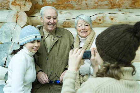 simsearch:696-03401677,k - Teenage girl photographing grandparents and sister with digital camera, waist up Stock Photo - Premium Royalty-Free, Code: 632-01613158