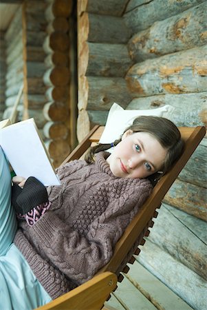simsearch:632-01193783,k - Teenage girl reading book, smiling at camera, dressed in winter clothing Stock Photo - Premium Royalty-Free, Code: 632-01613174