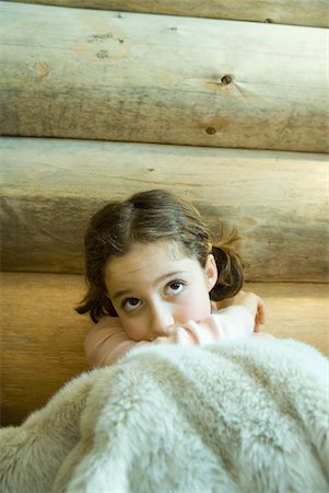 preteen girl mouth - Girl sitting under blanket, looking up, portrait Stock Photo - Premium Royalty-Free, Code: 632-01613182