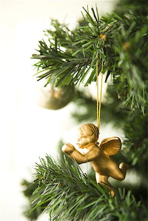 simsearch:632-06118429,k - Angel Christmas ornament hanging from Christmas tree, cropped view Stock Photo - Premium Royalty-Free, Code: 632-01613350