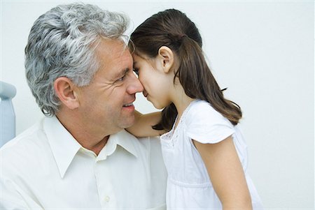 pictures of a little girl whispering - Little girl whispering to mature man, side view Stock Photo - Premium Royalty-Free, Code: 632-01638759