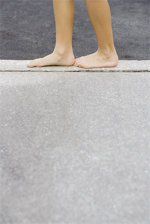 simsearch:695-03378125,k - Child standing on edge of concrete, cropped view of calves and bare feet, side view Stock Photo - Premium Royalty-Free, Code: 632-01638855